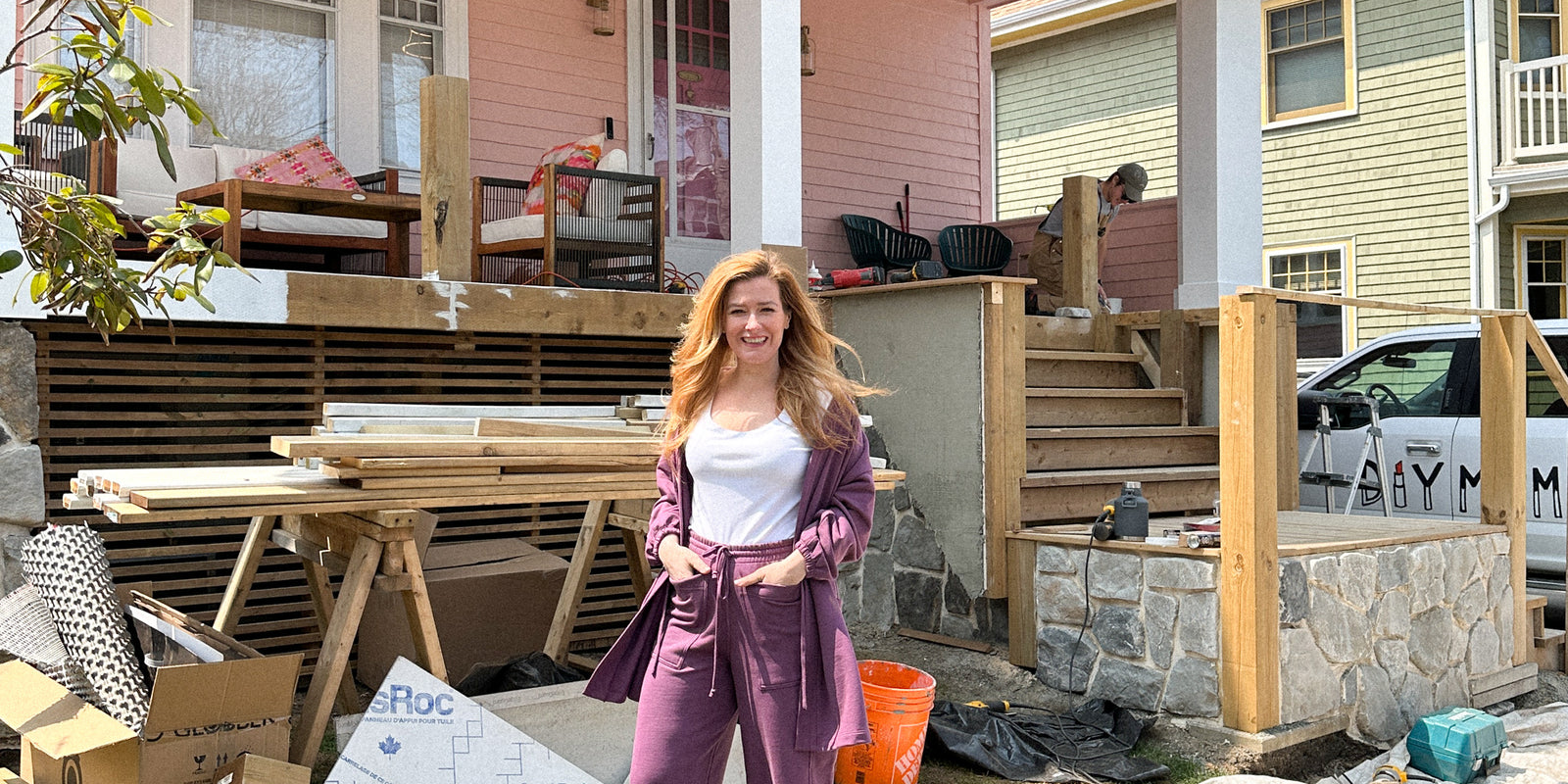 Rebekah Higgs aka DIY Mom sitting on the bed in her home 